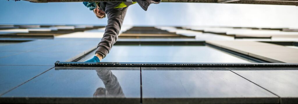 A window cleaner in action on a high-rise building, reflecting modern architecture.