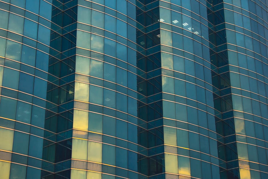 A contemporary glass facade in Kowloon showcasing modern architectural design.