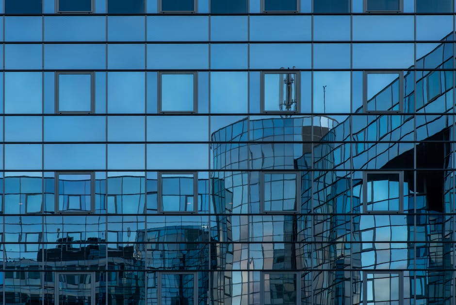 Reflection of urban architecture in modern glass building facade.